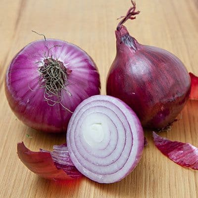 Uniform size firm Indian onions with natural pinkish-red skin